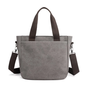 Minimalist grey canvas tote bag with dark brown straps and detachable shoulder strap