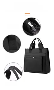 Detailed view of durable black nylon bag showing zip closure and reinforced handle straps