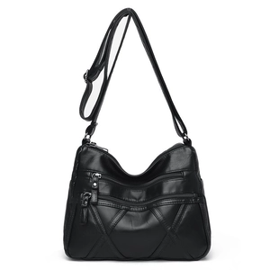 Black textured PU leather crossbody bag with multiple zippers and adjustable strap