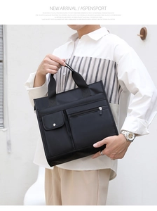 Close-up of black waterproof nylon briefcase with multiple compartments and reinforced handles