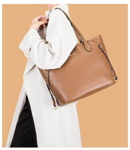 Caramel brown crocodile embossed tote bag detail with gold logo and shoulder strap