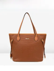 Front view of a brown crocodile embossed tote bag with gold metal logo and handle detail