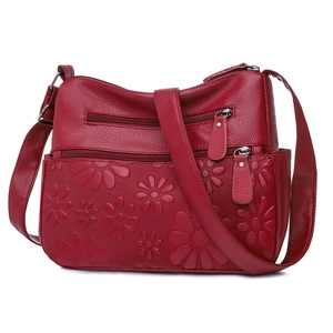Dark red leather shoulder bag with floral embossing and multi-zipper compartments