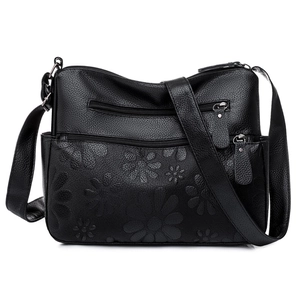 Black pebbled leather shoulder bag for women with floral embossing and silver zippers