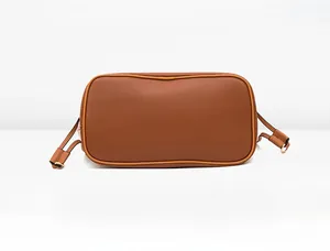 Detail view showing the reinforced rectangular base of the brown crocodile texture bag