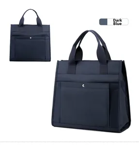 Detail view of water-resistant dark blue nylon laptop bag with metal snap pocket