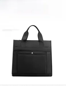Detail view of water-resistant black nylon business laptop bag with magnetic closure