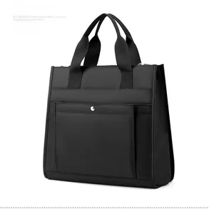 Detail view of water-resistant black nylon briefcase with metal buckle and reinforced handle