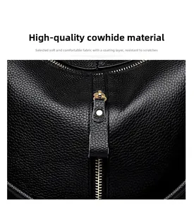 Close-up of black litchi grain leather texture and gold metal zipper on a soft handbag