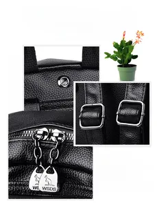 Detail of black pebbled leather backpack showing silver zippers and metal hardware