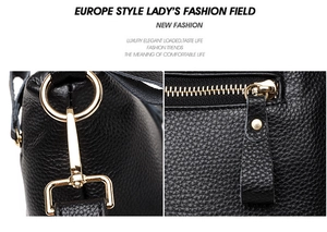 Detail of polished gold-tone hardware and smooth zipper on black pebbled leather bag