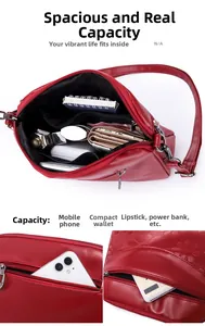 Detail view of red embossed leather crossbody bag with multi-layer zippers and high capacity