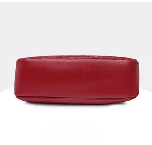 Detailed bottom view of a red lychee pattern leather shoulder bag for women