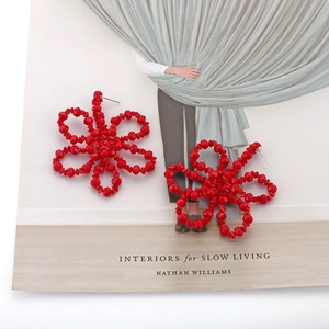 Handmade red crystal beaded flower drop earrings in a bohemian geometric style