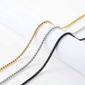 Three-color stainless steel box chain necklaces in gold, silver and black on white display