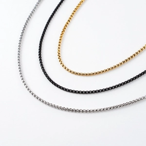 Detailed view of stainless steel box chains in gold, black and silver finishes