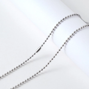 Detailed view of polished stainless steel ball bead chain with a cylindrical clasp