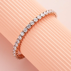 Macro view of rose gold tennis bracelet with brilliant cubic zirconia in claw setting