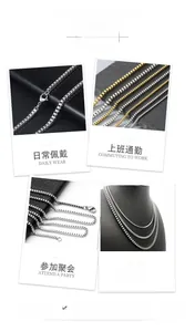 Detail of 18K gold and silver stainless steel box chain with secure lobster clasp