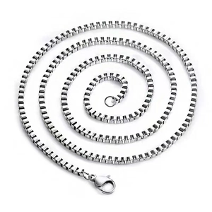 Macro view of polished silver box chain necklace with a secure lobster clasp closure