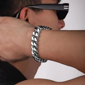 Gros plan d'un bracelet gourmette argenté pour homme avec finition polie au poignet
