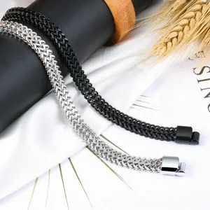 Detail of woven wheat style stainless steel bracelets in black and silver finishes