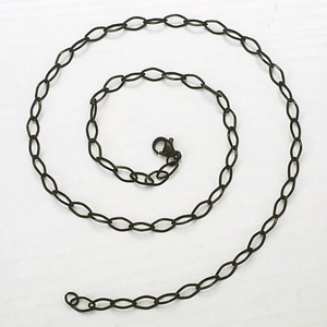 Detailed macro view of vintage bronze diamond-cut chain with a classic lobster clasp