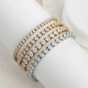 Gold and silver stainless steel tennis bracelets with round zirconia on display