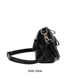 Side view of black lychee grain leather handbag featuring elegant gold metal hardware