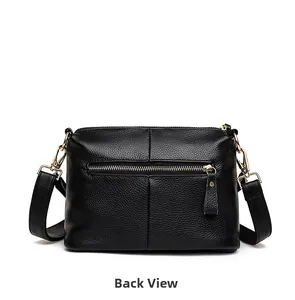 Rear view of black pebble leather handbag featuring a zippered pocket and gold hardware