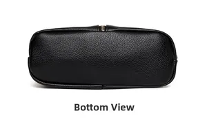 Detailed bottom view of a black leather tote showing textured grain and neat stitching