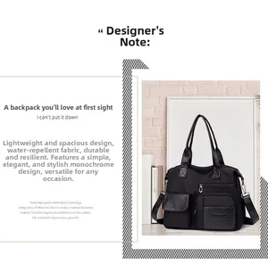 Detail view of water-resistant nylon tote bag with functional exterior pockets and zippers