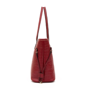 Side view of a red crocodile embossed tote bag with gold ring hardware on white background