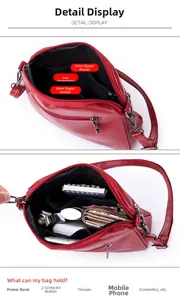 Detailed interior of red leather crossbody bag showing main pockets and zipper compartments