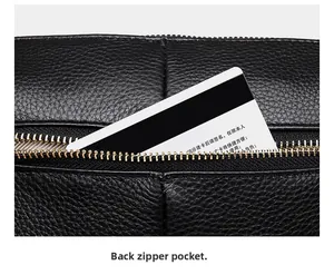 Close-up of black lychee grain leather handbag featuring a secure back zipper pocket
