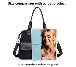 Black nylon tote bag size comparison with A4 magazine showing spacious interior capacity