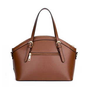 Dark brown crocodile embossed shell handbag with gold hardware on white background