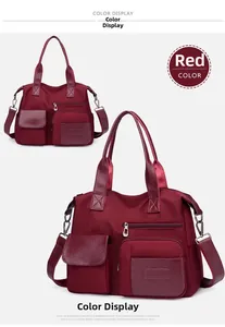 Detail view of burgundy nylon tote bag with multiple pockets and synthetic leather trim