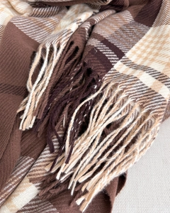 Close-up of brown and beige plaid cashmere-feel scarf with soft tassels and woven texture