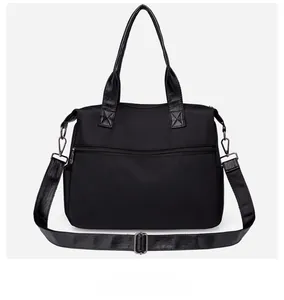 Detail view of the waterproof nylon tote bag with back zipper pocket and adjustable strap