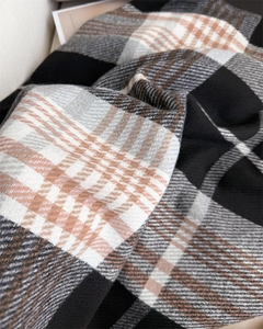 Detailed texture of thick plaid tassel scarf in black, white and brown cashmere feel