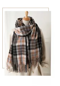 Detailed close-up of the classic brown and black plaid scarf texture with tassel edges
