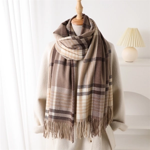 Plaid cashmere-like tassel scarf in brown and cream earth tones on a wooden mannequin