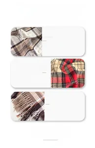 Detail of classic brown plaid scarf with long fringe and wool-rich breathable texture