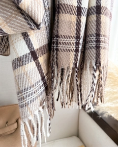 Detailed view of brown checkered cashmere-like scarf texture and hand-twisted tassels