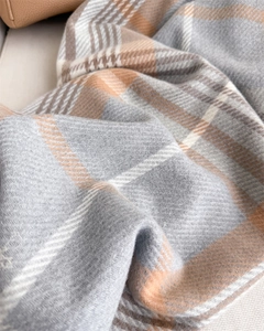 Detail of soft plaid scarf texture in grey and camel with fine twill weave pattern