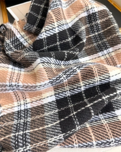 Macro shot of soft brushed fabric texture on classic brown and black plaid scarf