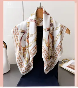 Detailed equestrian print on silk-like scarf with gold chains and leather belt motifs