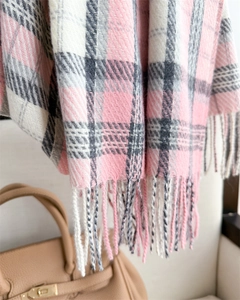 Close-up of pink, white and grey plaid scarf with fringes and soft cashmere-like texture