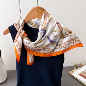 Elegant equestrian print silk scarf with classic gold chain and horse harness patterns